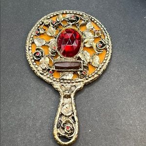 Vintage 4” hand mirror with leaf pattern